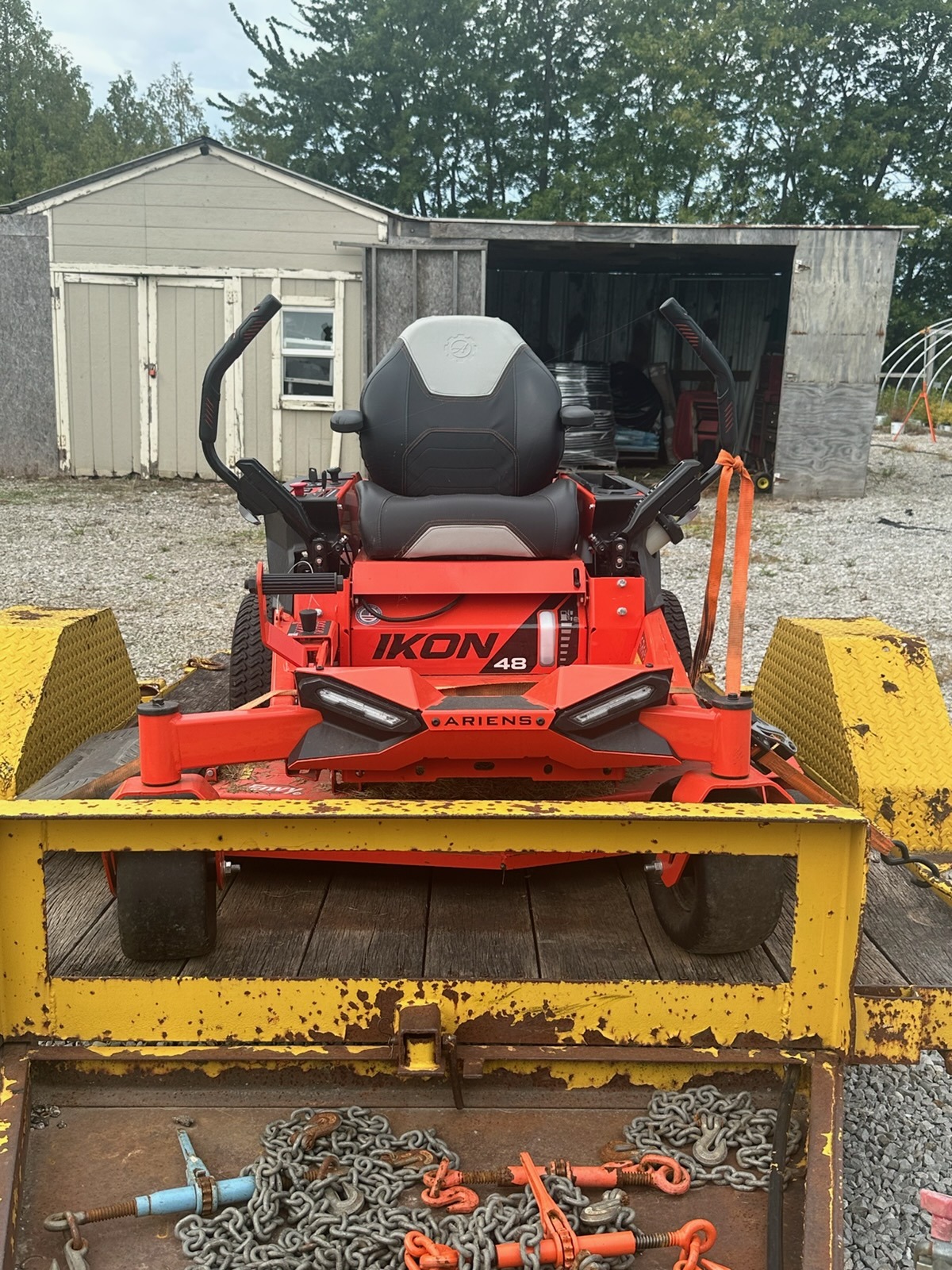 A red zero-turn mower ready for lawn care work